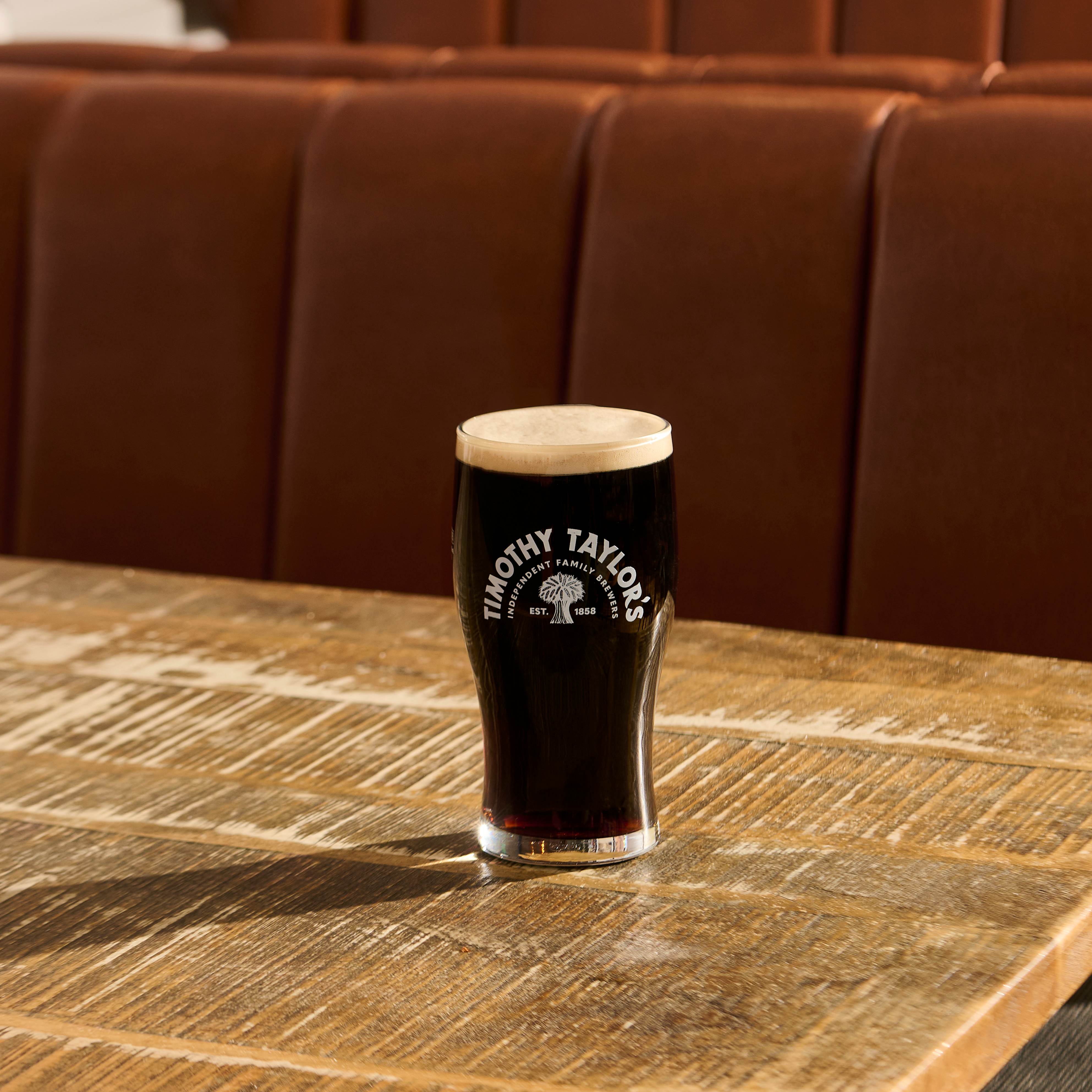 Pint of Timothy Taylor’s Stout with a creamy white head.
