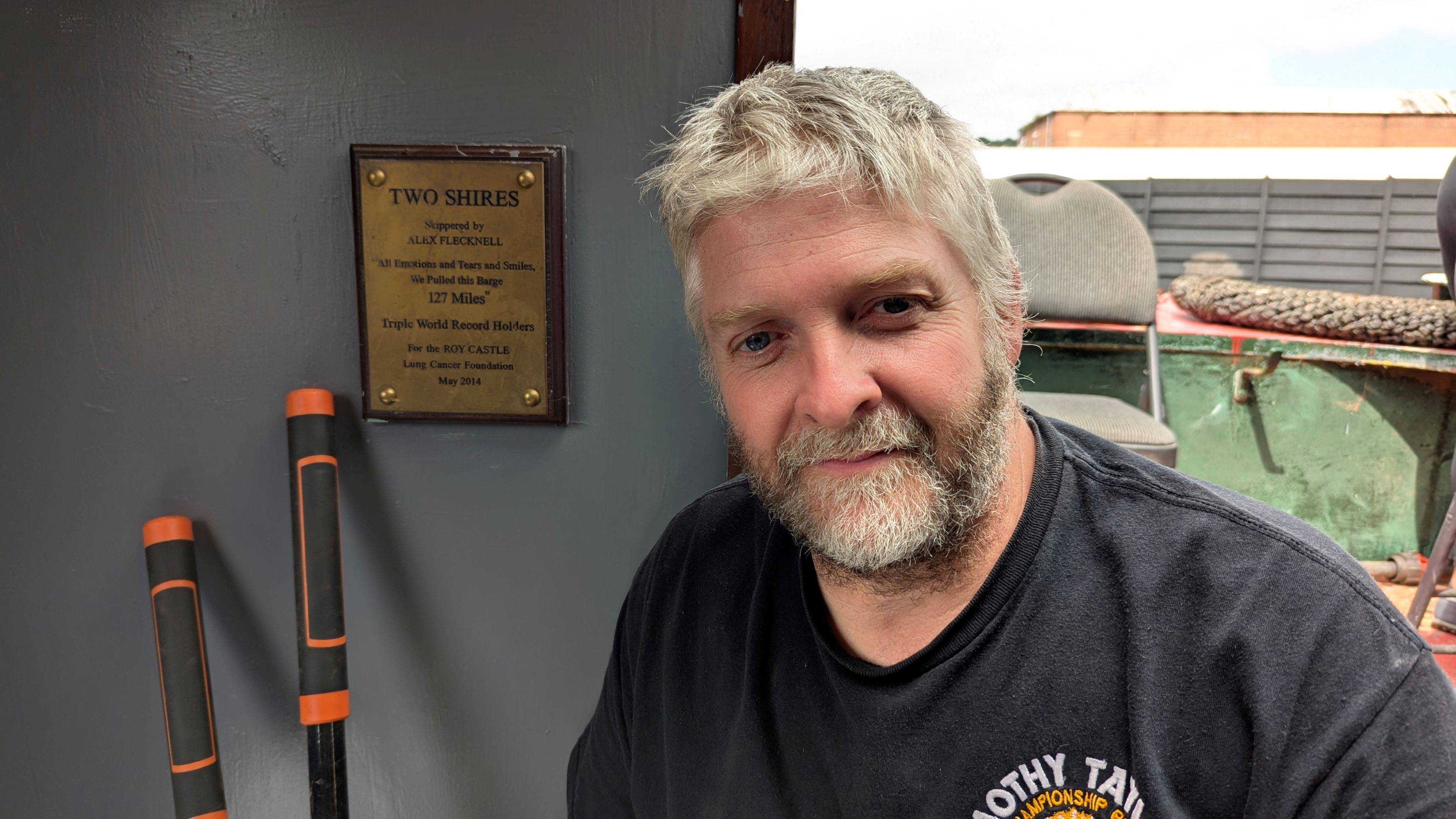 Dave Jafrate pictured with plaque honouring his barge pull World Records