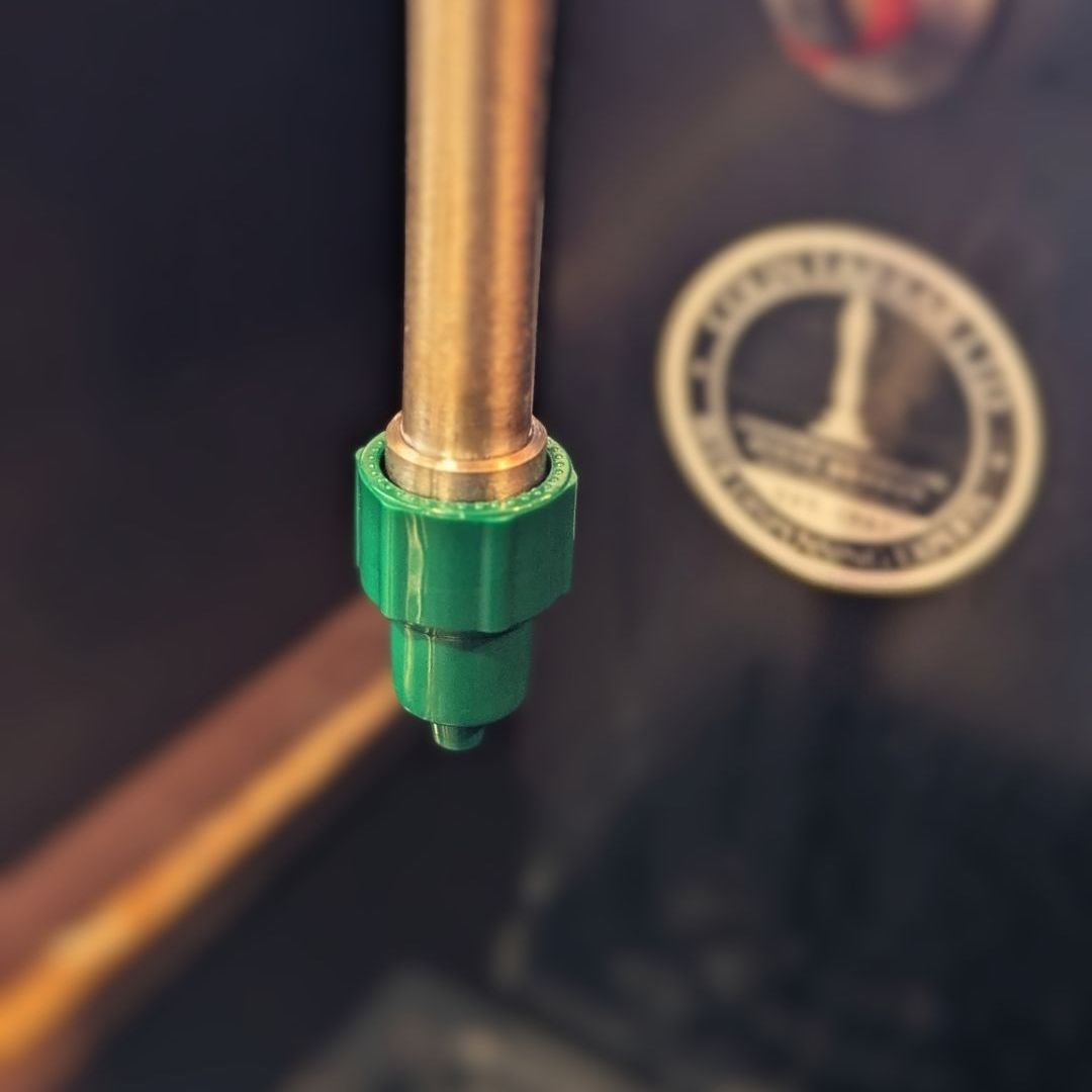 A green sparkler nozzle attached to a beer engine spout.