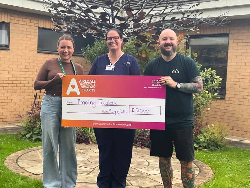 Alex and Scott from Timothy Taylor's Charity Committee presenting cheque to Sunbeam Support Group